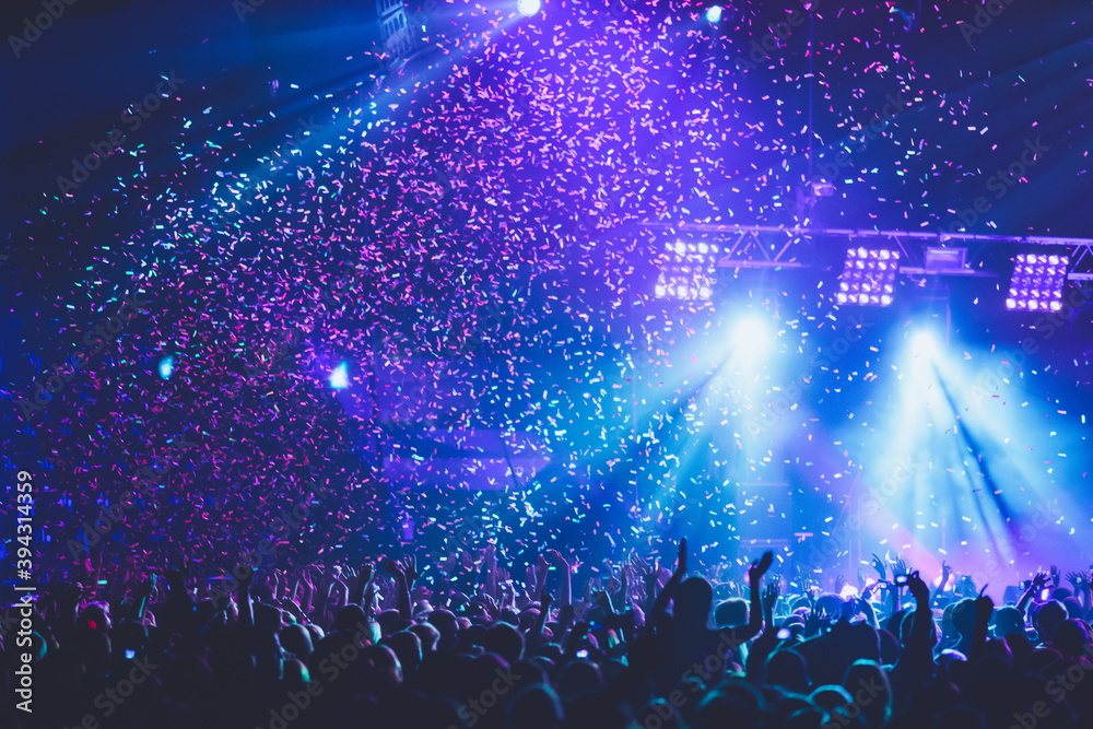 Wall mural a crowded concert hall with scene stage lights, rock show performance, with people silhouette, colou