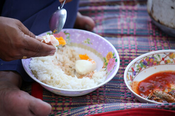 person holding a bowl of rice