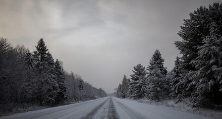 Winter snow storm and snow covered road in Upper Peninsula of Michigan.