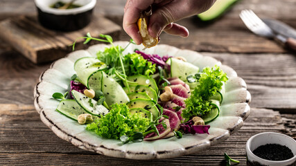 Healthy food, Salad from radish, avocado, microgreen, cabbage, cucumber and lettuce leaves. Top view. Flat lay
