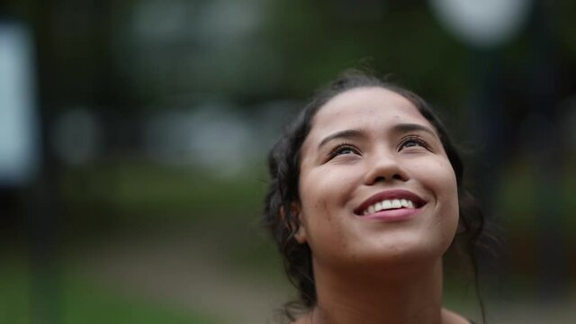 Happy hispanic girl opening eyes with HOPE and FAITH, woman face smiling feeling FREEDOM