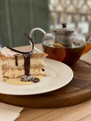 the chocolate cake and cup of tea, vertical