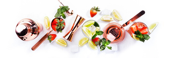 Mojito mocktail set with lime, mint, strawberry and ice on white background. Cold alcoholic...