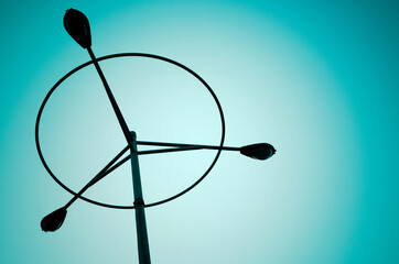 Silhouette of three street lamp structure. Toned image.