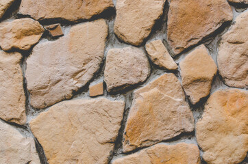 Abstract Grunge Stonewall Background. Stone wall background. Decorative Finishing Wall Fence of Natural Stone. Rough Surface Rock Texture. Toned image.
