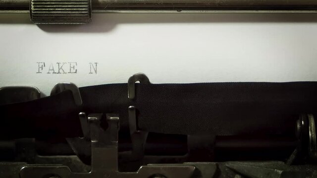 close up of typewriter typing fake news