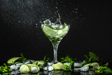 Gin-tonic alcoholic cocktail. liquor, ice. Freeze motion, drops in liquid splash