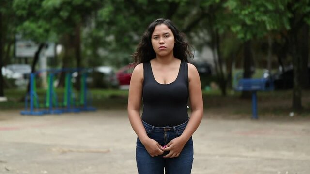 Latina hispanic teen girl standing outside in park