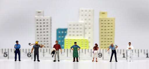 The concept of economic activities in social distance. Various miniature people standing  in front...