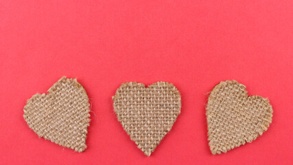 Pink background with wooden hearts