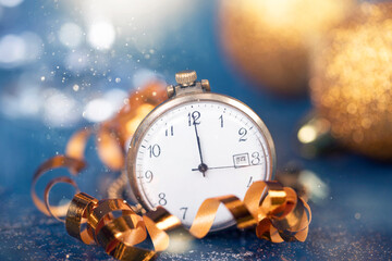 New Year's at midnight - Old clock with Christmas decoration, champagne and holiday lights