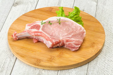 Raw pork bone steak over wooden