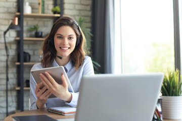 Freelance business women using tablet working call video conference with customer in workplace at home.