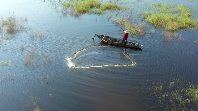 Aerial view from drone. Asian fishermen use traditional fishing nets in the lake in the morning.