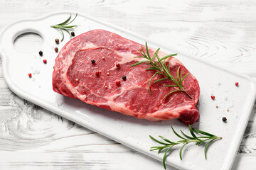 Raw fresh meat Ribeye steak entrecote of Black Angus Prime meat on white wooden background