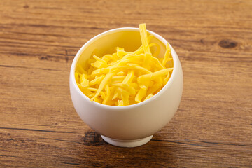 Shredded yellow cheese in the bowl
