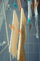 Towels hanging on strings with clamps. Toned image.