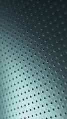 Dark metallic phone wallpaper. Perforated aluminum surface with many holes. Tinted blue or green industrial background. Vertical metal backdrop. Macro