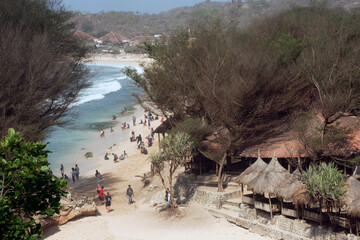Views of beaches in the morning on holiday seasons with people and tourists swimming and sunbathing captured high angle.