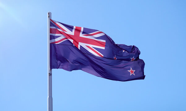 New Zealand flag flying on blue sky
