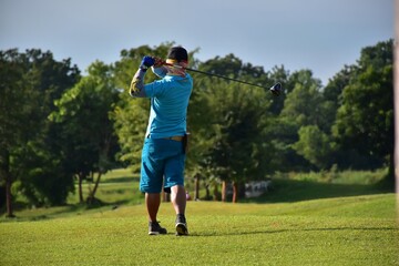 person golfing on the grass