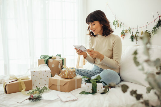 Woman with christmas gifts and letters