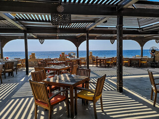 restaurant with stripped shadow on a terrace