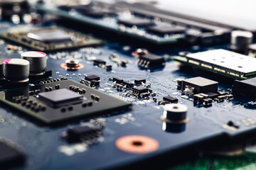 Close-up printed circuit board with electronics components. Macro photography for electric background. PCB with microchip, processor and SMD & IC mounted components.