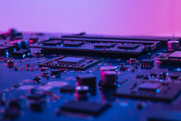 Abstract computer background with electronic device, neon colors toned. Macro photography of...