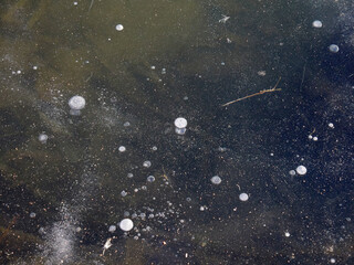 Blizzard and snowstorm on a frozen pond. A river covered with ice and snow in winter.