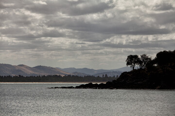 Fototapeta na wymiar View of the coastline along the Derwent River at Opposum Bay