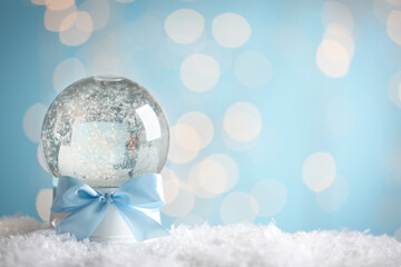 Beautiful snow globe against with Christmas festive lights. Space for text