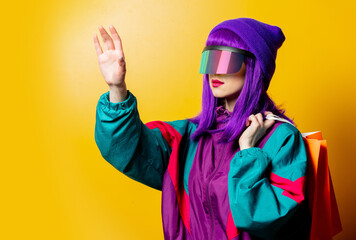 Style woman in VR glasses and 80s tracksuit with sopping bags