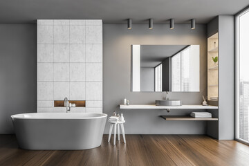 Bathroom in grey and wooden design with row of bathtub, sink and mirror