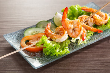 Skewers Barbeque grilled prawns on wooden table