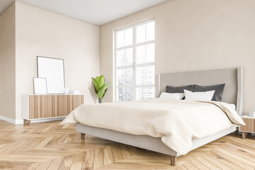 Wooden bedroom with frame canvas, bed and linens, beige walls and window