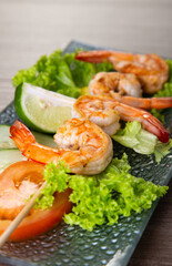 Skewers Barbeque grilled prawns on wooden table