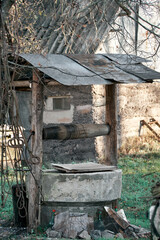 abandoned concrete well in the courtyard of the village, morning
