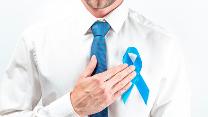 November. Hipster men in bright shirt, cyan tie with blue ribbon in hands on white background....