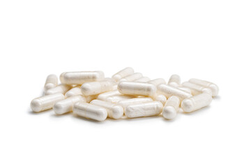Fototapeta na wymiar Close-up of a pile of yellow colored pills or capsules on isolated white background. Selective Focus.