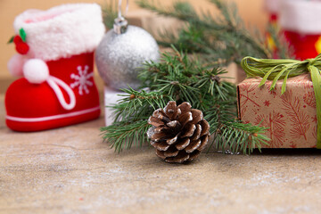 Christmas composition. Gifts, fir tree branches, decorations on kraft background. Christmas, winter, new year concept.