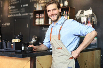 Fototapeta premium Small business owner working at his cafe.