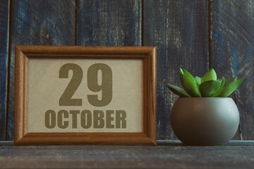 october 29th. Day 29 of month, date in frame next to succulent on wooden background autumn month, day of the year concept