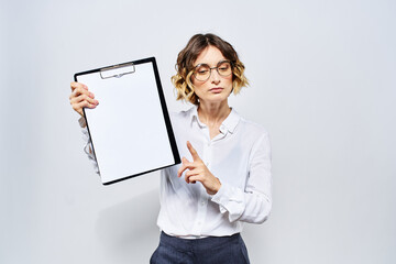 Business woman with a folder of white documents in her hand on a light background And hairstyle glasses model