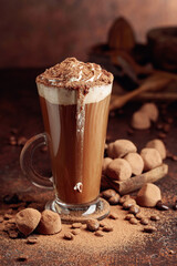 Truffles and glass of hot chocolate with whipped cream.
