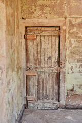 Fototapeta na wymiar old wooden door of an abandoned saltpeter mining town in the Atacama desert of Chile, South America