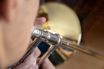 selective focus of a teenager playing a trombone