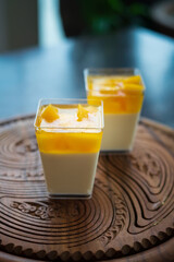 Mango Panna cotta with mango jelly, Italian dessert, homemade cuisine in a container.