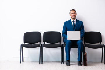 Young businessman waiting for an interview at hall