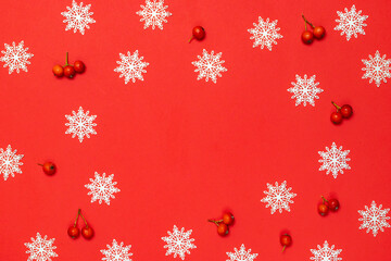 New year pattern. White snowflakes, red berry in Christmas composition on red background for greeting card. Christmas, winter, new year concept.